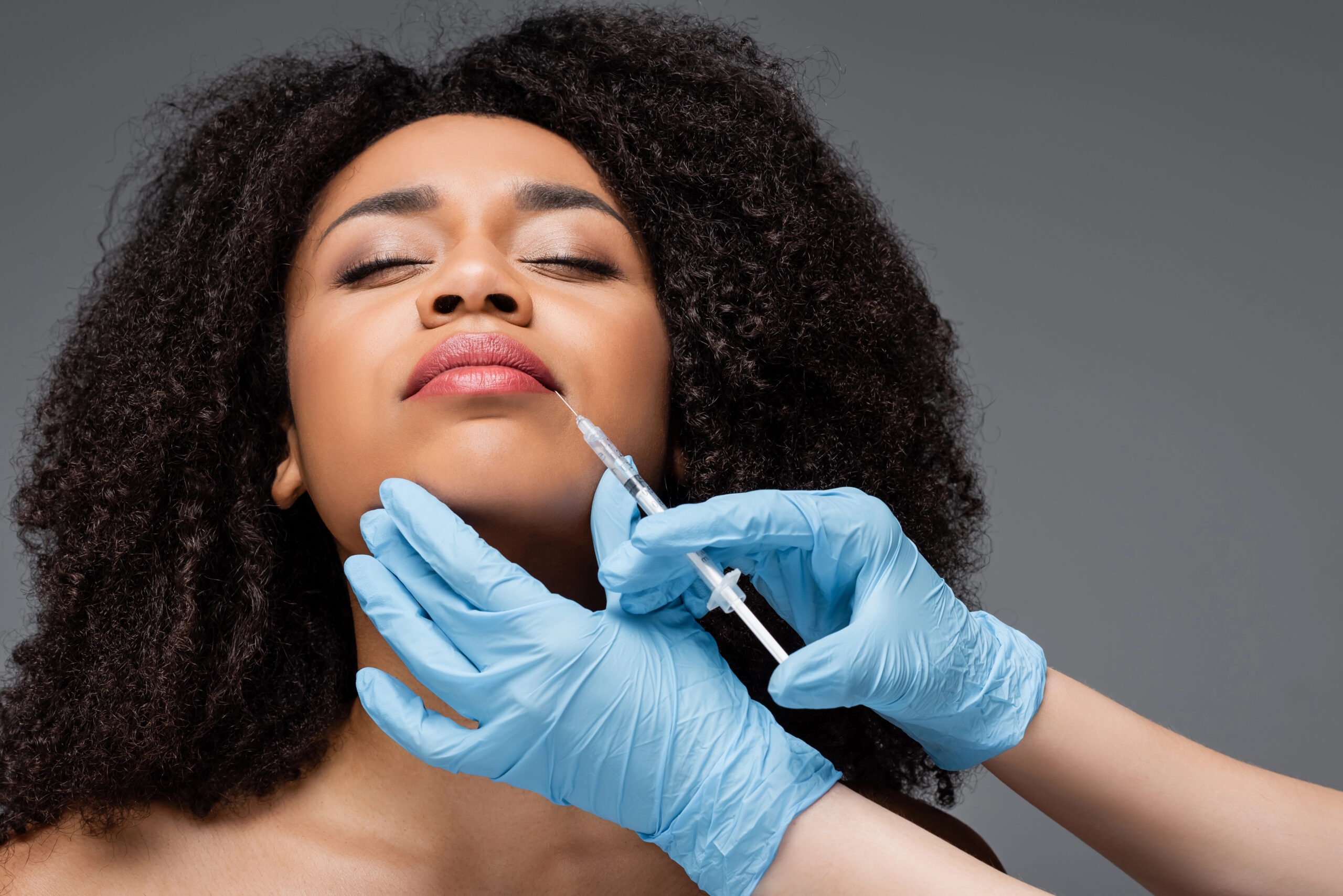 Black woman receiving an injectable aesthetic solutions from FACE Secrets of Florida Dr. Daudrie Anne Powell, DDS